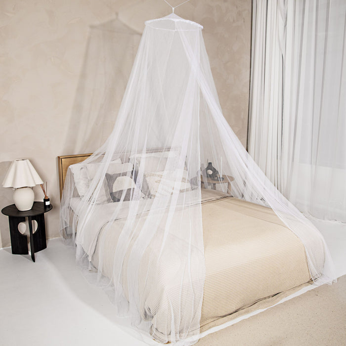 A person peacefully sleeping under a mosquito net, surrounded by a protective barrier that keeps mosquitoes at bay.