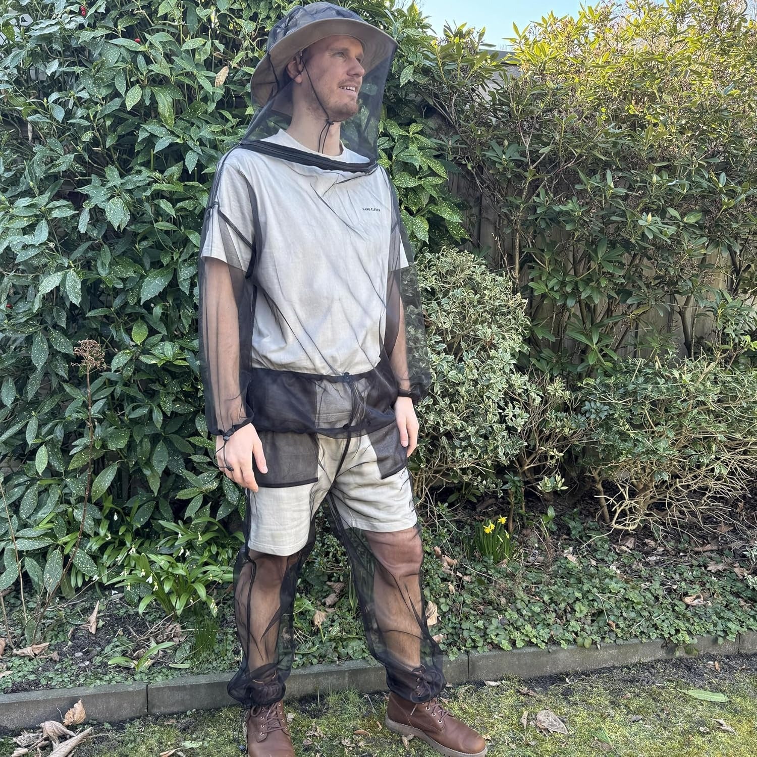 Adjustable mosquito net clothing set with removable hood, zippered pockets, and secure fit, perfect for outdoor travel and camping trips