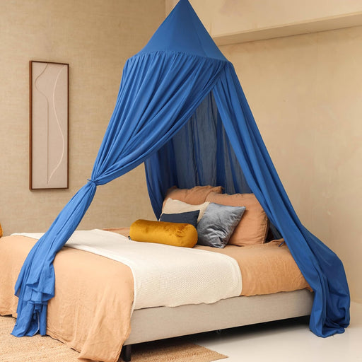 Blue bed canopy hanging over Queen size bed in elegant bedroom