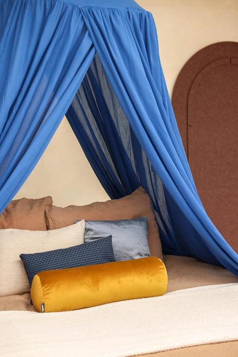 Blue conical canopy draped over bed for serene bedroom style