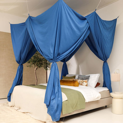 Blue rectangular bed canopy hanging over Queen size bed in elegant bedroom