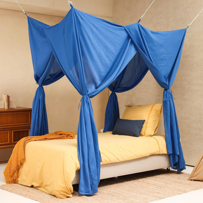 Blue rectangular bed canopy hanging over single bed in modern bedroom