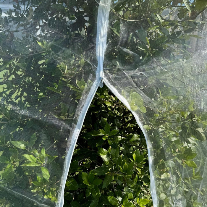 Durable white mesh net cover protecting fruit trees from birds, insects, and pests.