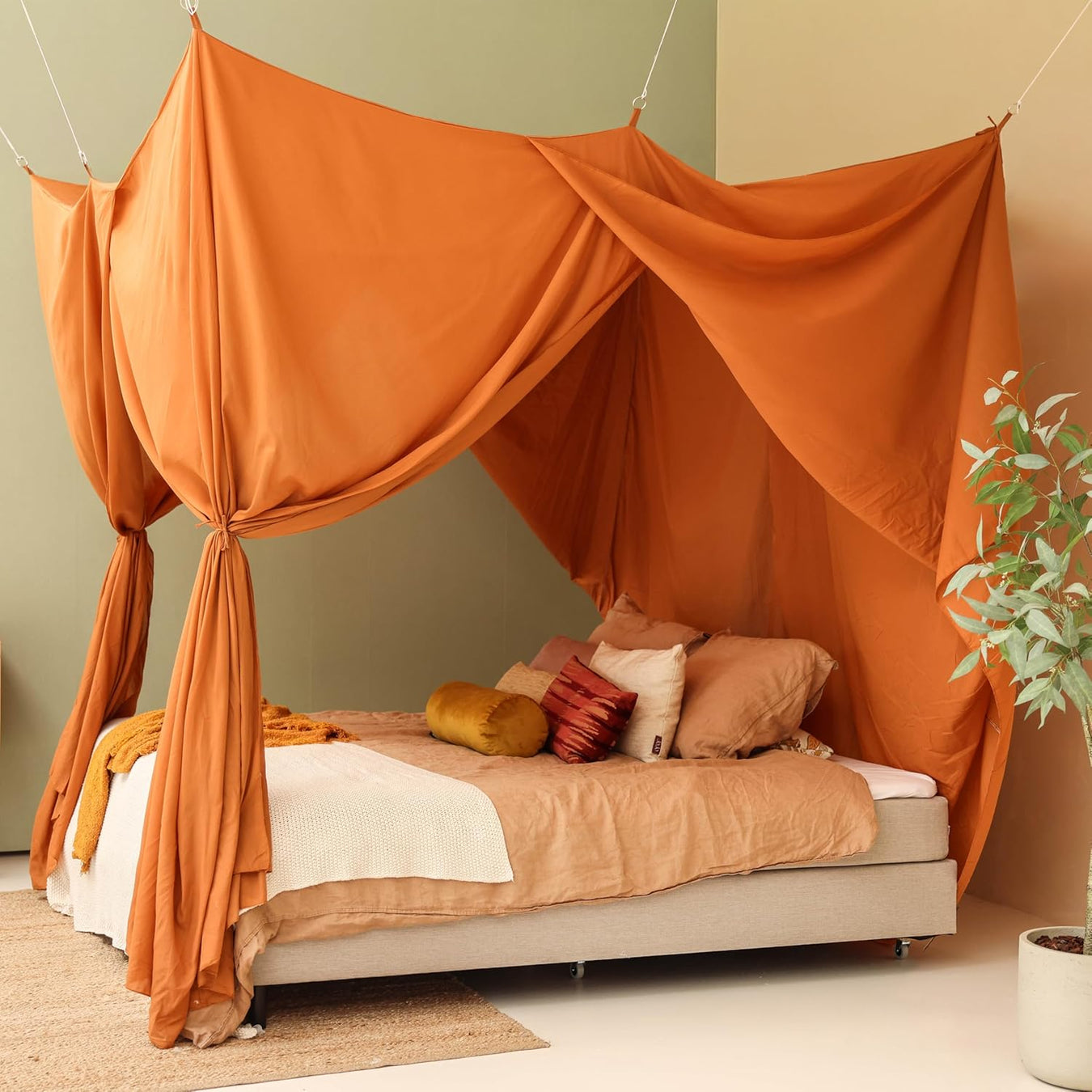 Caramel rectangular bed canopy hanging over Queen size bed in elegant bedroom