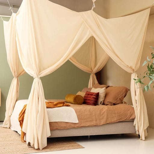 Cream beige bed canopy hanging over Queen size bed in elegant bedroom