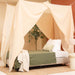 Cream beige rectangular bed canopy hanging over single bed in cozy bedroom