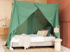 Stylish green mosquito net canopy adding elegance to bedroom décor
