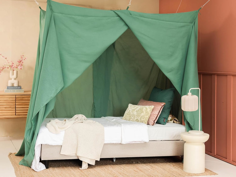 Stylish green mosquito net canopy adding elegance to bedroom décor
