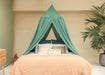 Green conical canopy draped over bed for decorative bedroom style