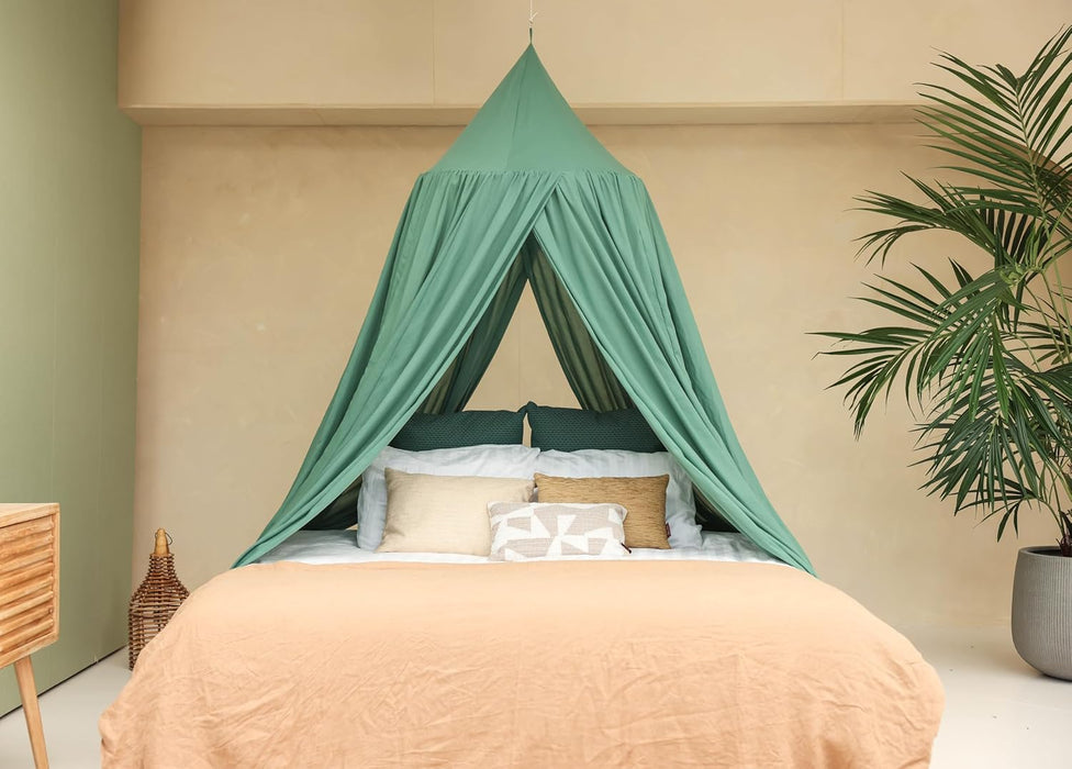 Green conical canopy draped over bed for decorative bedroom style