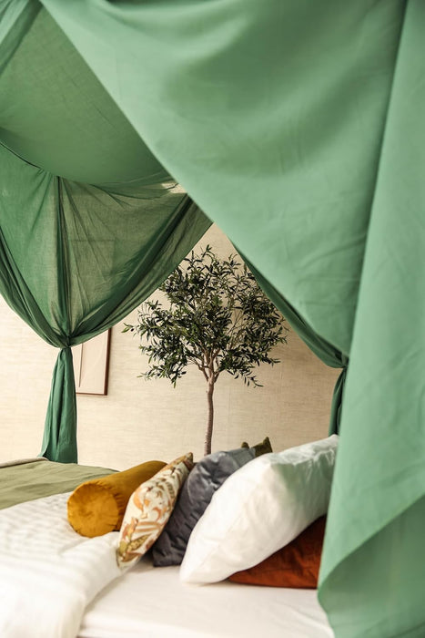Luxurious green mosquito net creating a cozy bedroom atmosphere