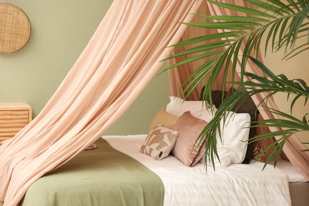Conical nougat canopy draped over bed for warm bedroom style