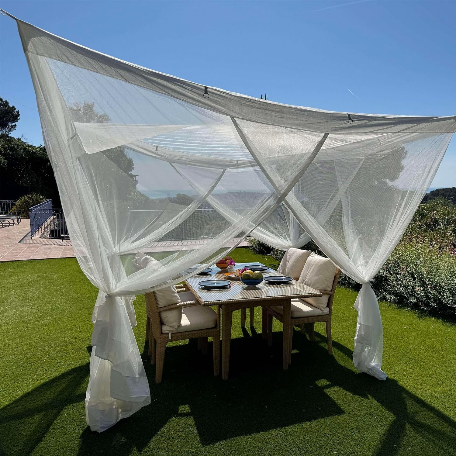 White Outdoor Mosquito Net set up on a patio, showcasing its spacious interior