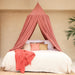 Pink bed canopy hanging over Queen size bed in stylish bedroom