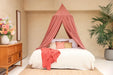 Conical pink canopy draped gracefully over bed for feminine style
