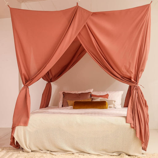 Pink rectangular bed canopy hanging over Queen size bed in elegant bedroom