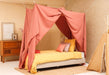 Pink bed canopy covering single bed for dreamy and soft look
