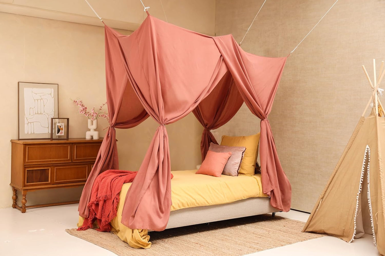 Pink rectangular bed canopy hanging over single bed in elegant bedroom