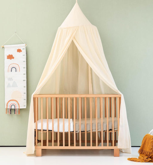 Cream nursery canopy for reading nook or playroom setup