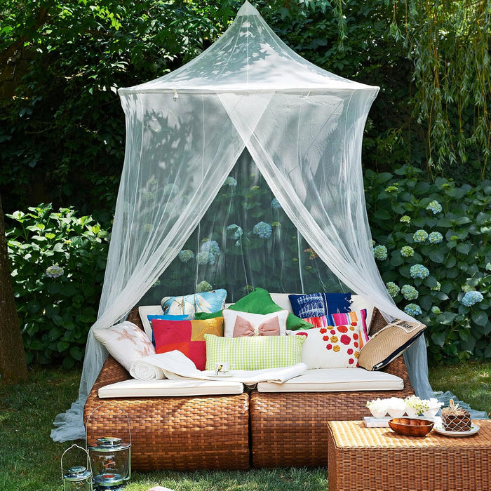 Large mosquito net with wide base offering full coverage for bed or outdoor seating area